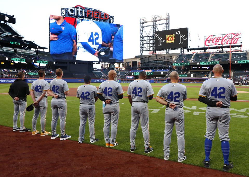 Pittsburgh Pirates stand on the third base line wearing number 42 in honor of Jackie Robinson Day before a baseball game against the New York Mets Monday, April 15, 2024, in New York. (AP Photo/Noah K. Murray)