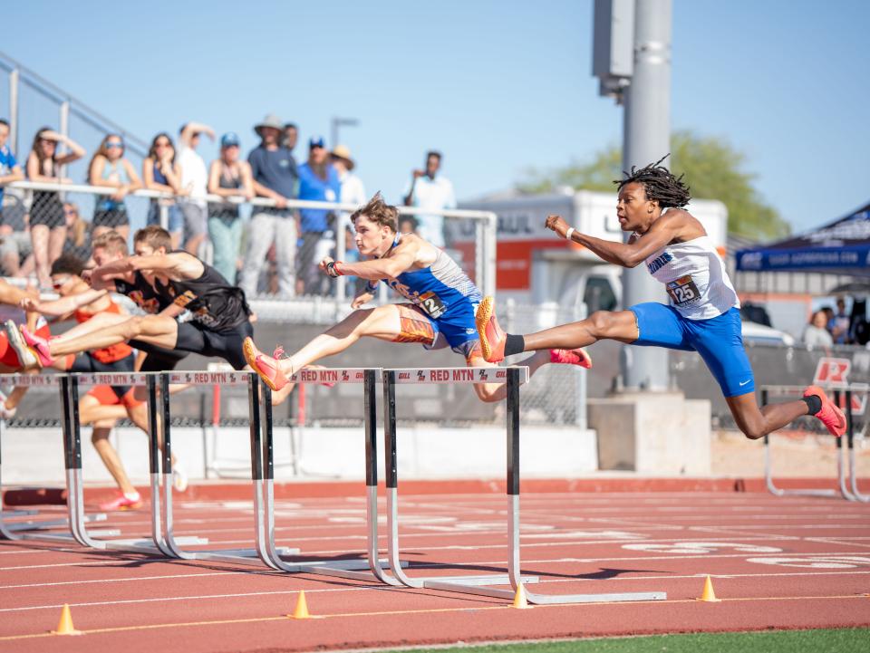 Athletes compete in a hurdle event at the track and field championships at Red Mountain High School in Mesa on May 6, 2023.