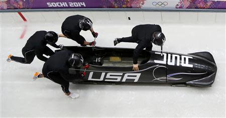 Pilot Steven Holcomb of the U.S. (R) and his teammates start during a four-man bobsleigh training event at the Sanki Sliding Center in Rosa Khutor, during the Sochi 2014 Winter Olympics February 20, 2014. REUTERS/Murad Sezer