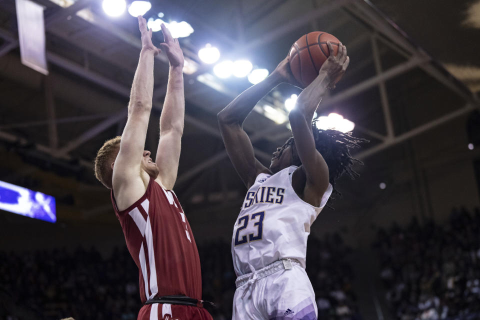 Washington guard Keyon Menifield shoots against Washington State guard Jabe Mullins during the first half of an NCAA college basketball game Thursday, March 2, 2023, in Seattle. (AP Photo/Stephen Brashear)