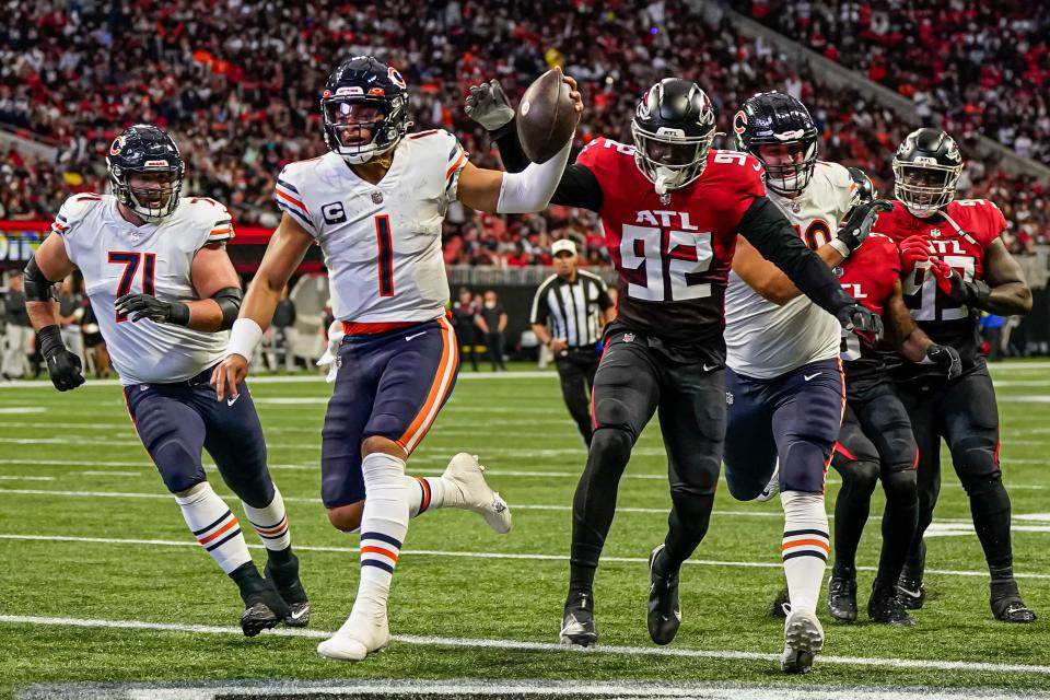 Chicago Bears quarterback Justin Fields (1) runs for a touchdown against the Atlanta Falcons at Mercedes-Benz Stadium.