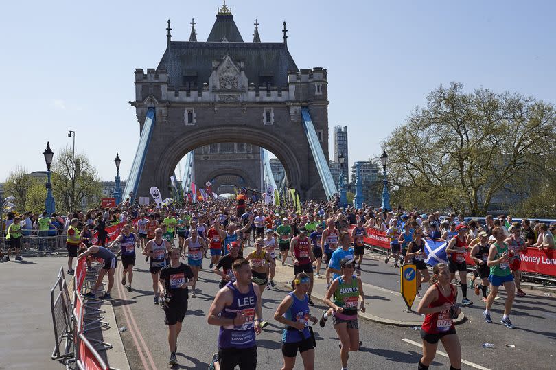 Runners pass the Tower of London during the London marathon