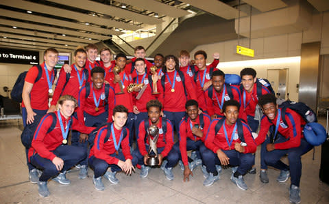 England U17s pose with the trophy after returning from India - Credit: PA