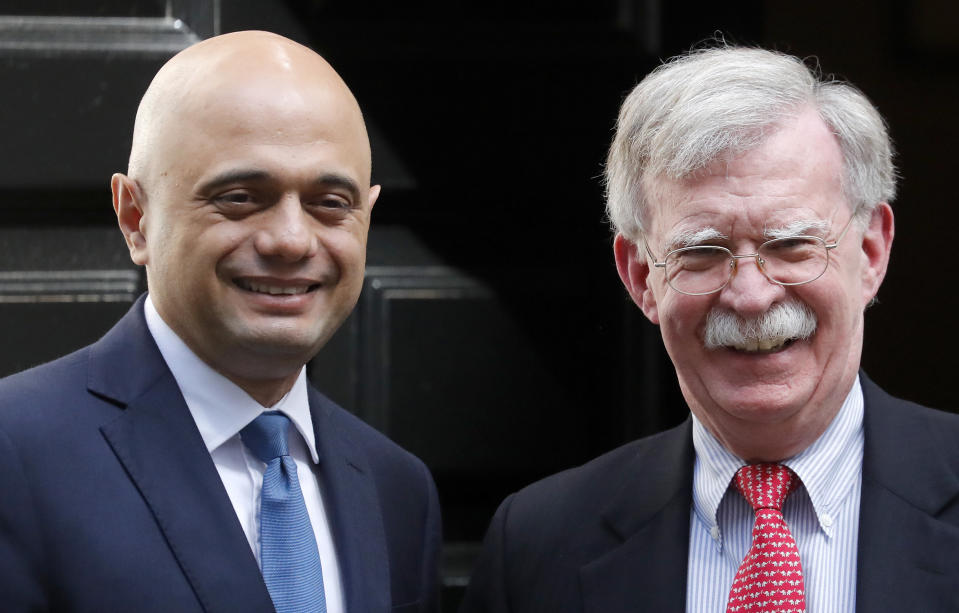 John Bolton, US National Security Advisor, right, is welcomed at Downing Street by Britain's Chancellor of the Exchequer Sajid Javid in London, Tuesday, Aug. 13, 2019.(AP Photo/Frank Augstein)