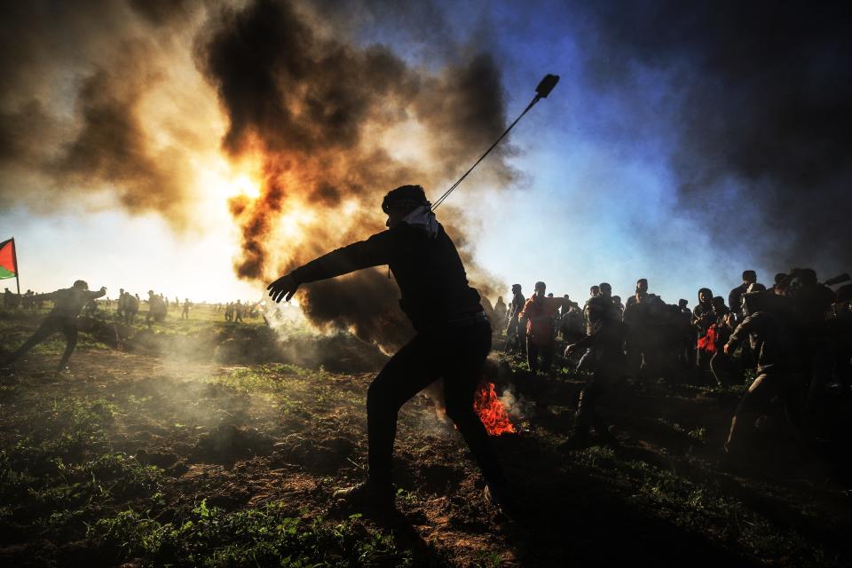 A Palestinian throws a stone with a slingshot towards Israeli security forces during the "Great March of Return" demonstration near the Shuja'iyya neighborhood in Gaza City, Gaza on March 8, 2019. (Photo: Ali Jadallah/Anadolu Agency/Getty Images)