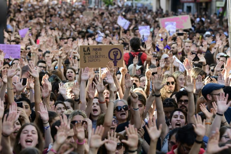 Protesters raise their hands at a rally in Madrid