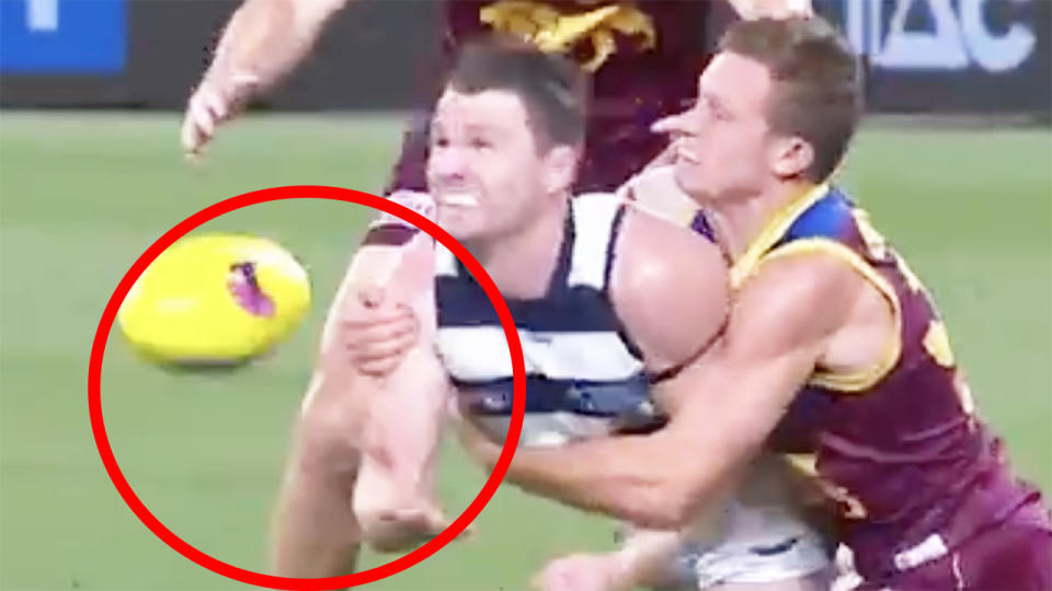 Geelong's Patrick Dangerfield is pictured throwing the ball to teammate Gary Ablett Jr.