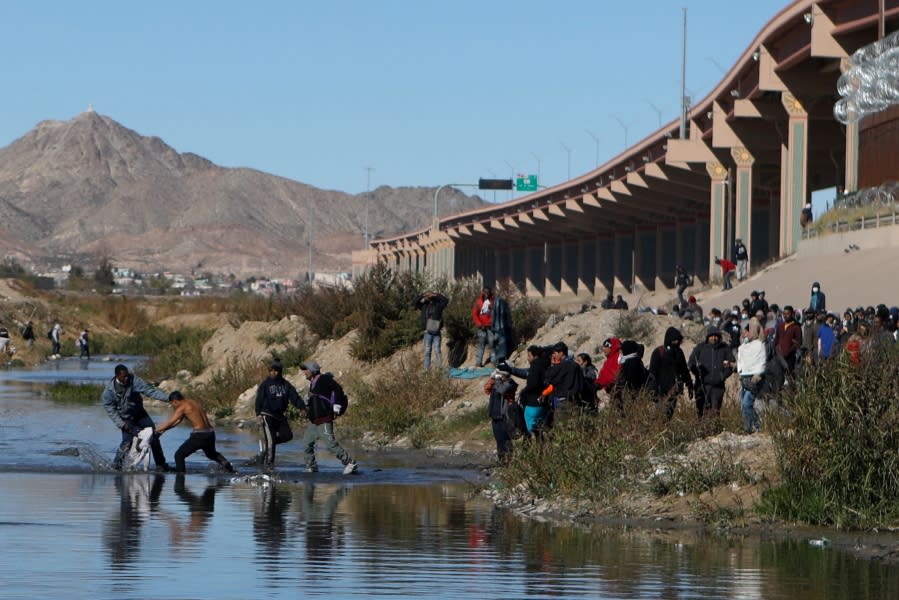 Migrants walk across the Rio Grande to surrender to US Border Patrol agents in El Paso, Texas, as seen from Ciudad Juarez, Chihuahua state, Mexico, on December 13, 2022. (Photo by Herika Martinez / AFP) (Photo by HERIKA MARTINEZ/AFP via Getty Images)