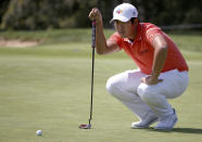 Byeong Hun An of South Korea lines up his putt on the first green during the Australian Open Golf tournament in Sydney, Thursday, Nov. 15, 2018. (AP Photo/Rick Rycroft)