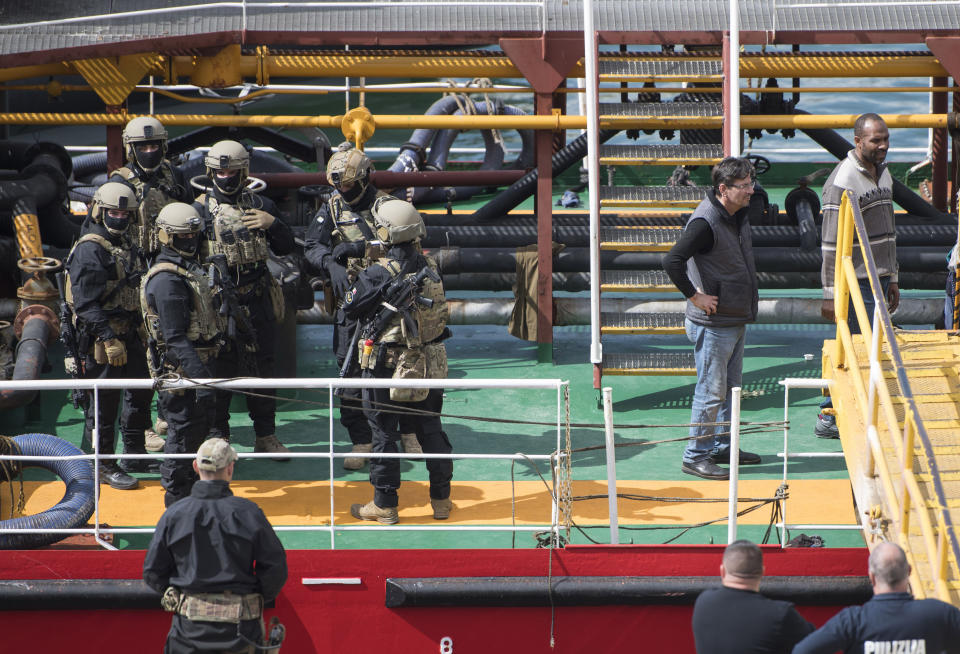 Armed forces stand onboard the Turkish oil tanker El Hiblu 1, which was hijacked by migrants, in Valletta, Malta, Thursday March 28, 2019. A Maltese special operations team on Thursday boarded a tanker that had been hijacked by migrants rescued at sea, and returned control to the captain, second from right, before escorting it to a Maltese port. (AP Photo/Rene' Rossignaud)