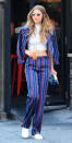 <p>During an N.Y.C. outing, Hadid donned a striped jacket and matching wide-leg pants that she wore over a white crop top and accessorized with sneakers.</p>