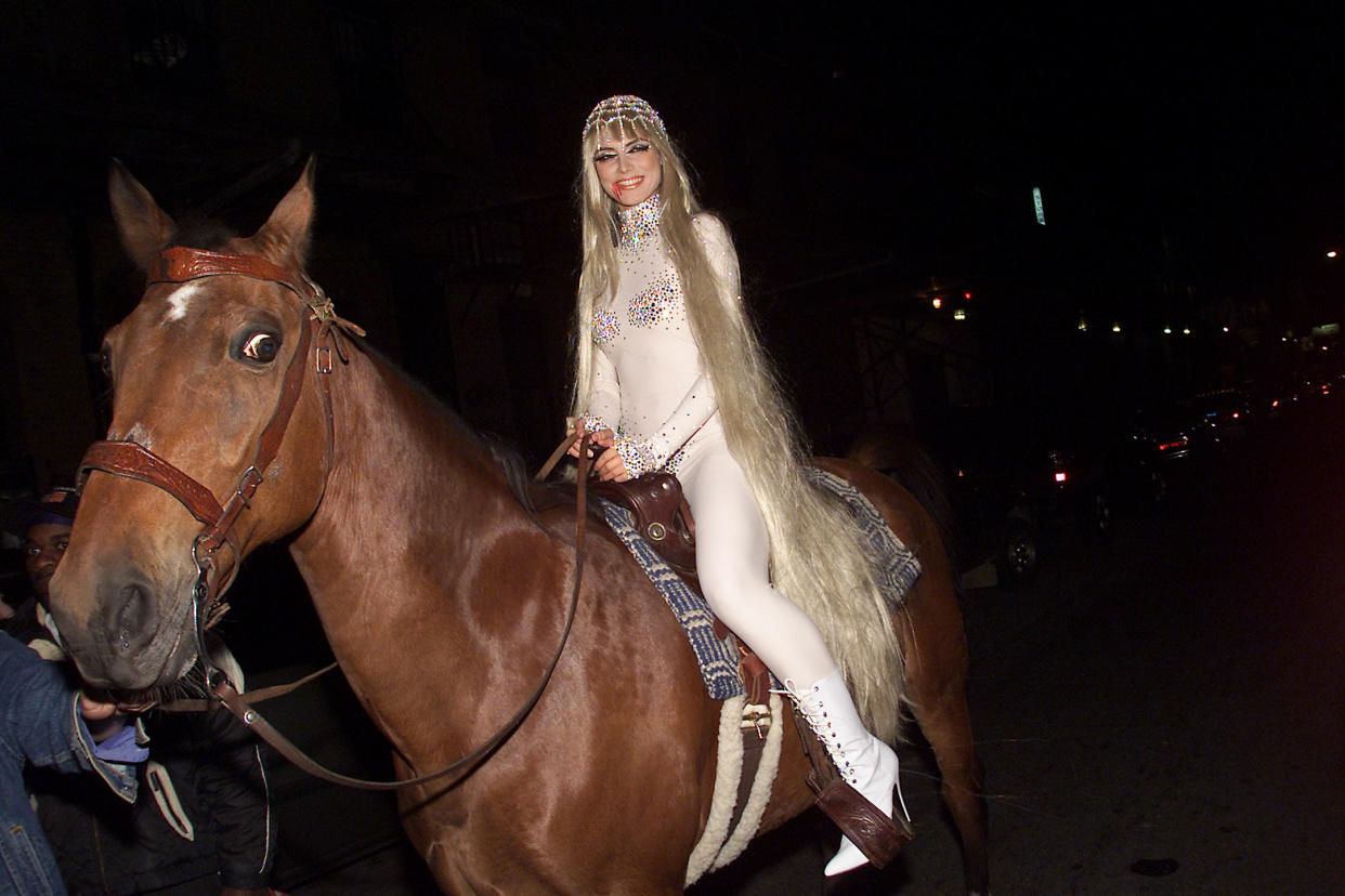 Model Heidi Klum arrives on horseback as Lady Godiva at her Annual Halloween Party at Lot 61 in New York City. 10/31/2001. Photo: Evan Agostini/Getty Images