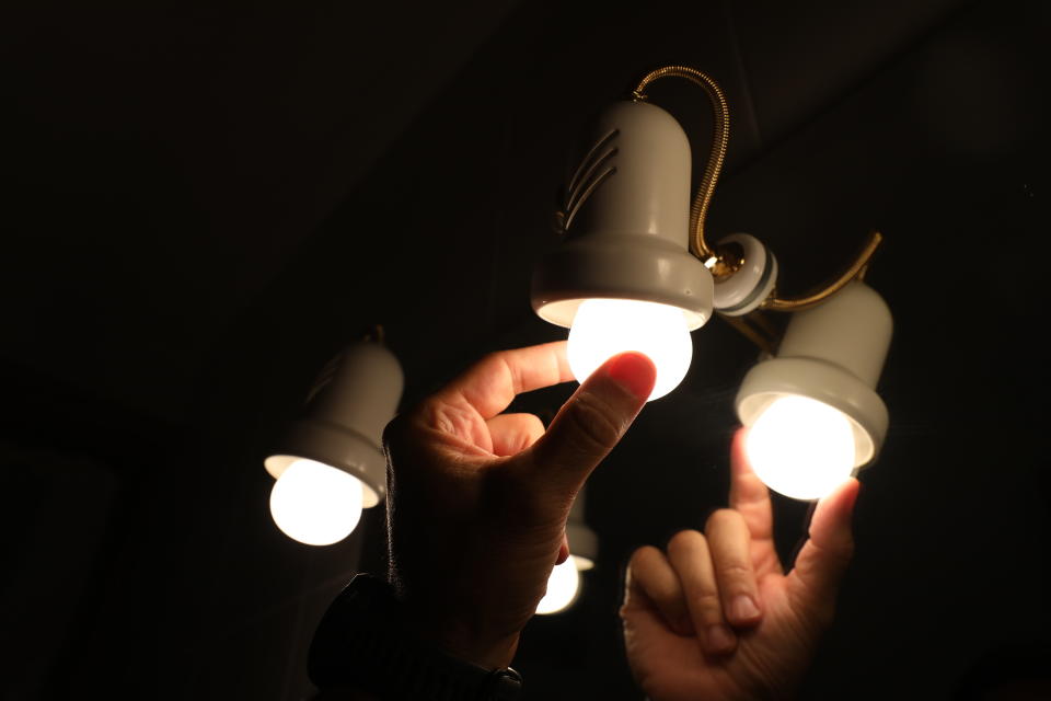 A person changes a light bulb.