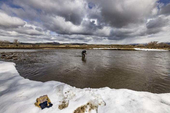 KREMMLING, CO - APRIL 24, 2022: Rancher Paul Bruchez, 40, checks for micro-organisms in the Colorado River at his ranch on April 24, 2022 in Kremmling, Colorado. The presence of the organisms means the river is healthy and coming back to life.(Gina Ferazzi / Los Angeles Times)