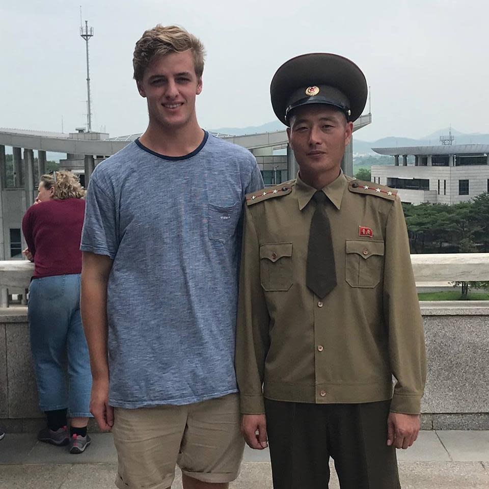 Alex snapped a picture with an army guard during a brave visit to North Korea last year. Photo: Facebook
