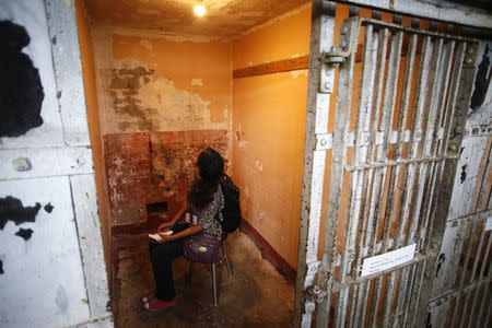 A member of the media experiences Ai Weiwei's installation "Stay Tuned" in cell block A of Golden Gate National Recreation Area's Alcatraz Island near San Francisco, California, September 24, 2014. REUTERS/Beck Diefenbach