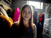 13-year-old daughter Anni walks through the family's house in Eisemroth, central Germany, Thursday, March 25, 2021. One year into the coronavirus pandemic, Katja Heimann is still trying to keep her spirits up _ despite several lockdowns and months of teaching seven of her children in home schooling. (AP Photo/Michael Probst)