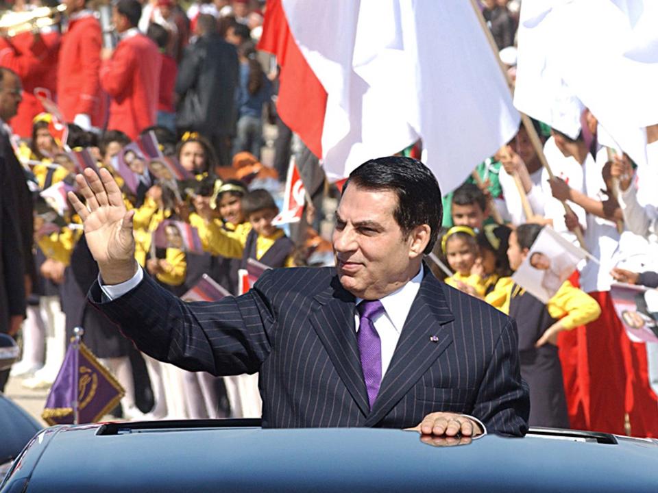 Former Tunisian president Zine El Abidine Ben Ali waves to the crowd at Rades stadium where he delivered his speech on the 50th anniversary of independence of Tunisia from France, 20 March, 2006: AFP/Getty Images