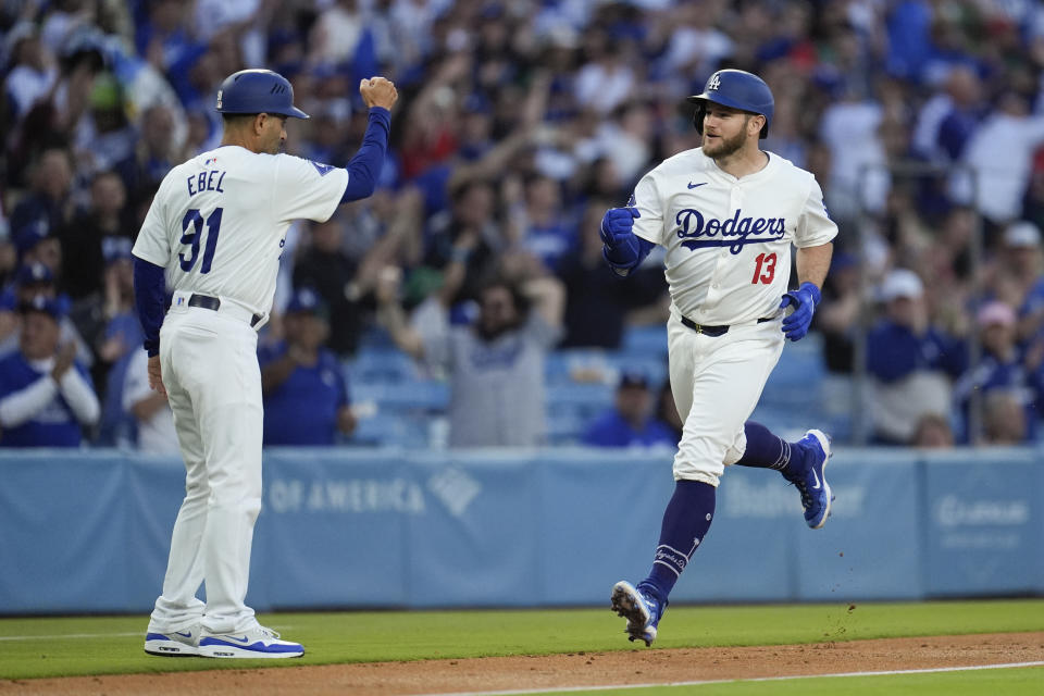 Los Angeles Dodgers' Max Muncy celebrates with third base coach Dino Ebel as he runs the bases after hitting a grand slam against the Miami Marlins during the first inning of a baseball game Tuesday, May 7, 2024, in Los Angeles. (AP Photo/Marcio Jose Sanchez)