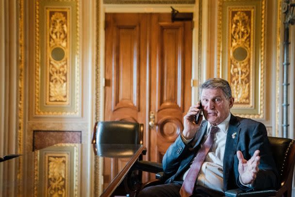 PHOTO: Sen. Joe Manchin talks on the phone with a staffer in the Senate Reception room of the U.S. Capitol, April 18, 2023, in Washington. (Kent Nishimura / Los Angeles Times via Getty Images)