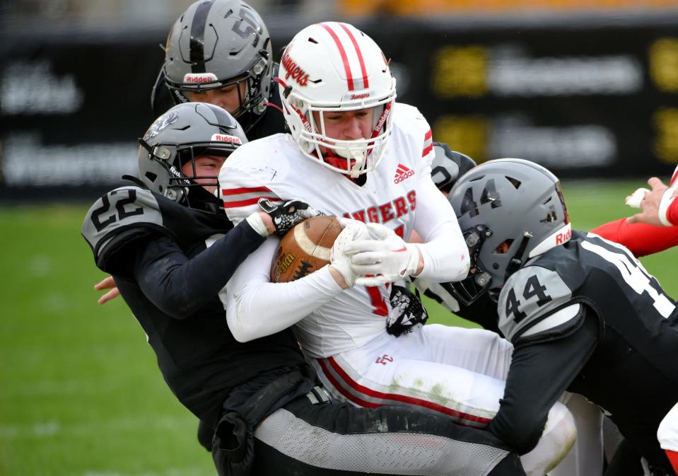 South Side's Andrew Corfield (22) and Mateja Pavlovich bring down Fort Cherry's Shane Cornali during Friday's Class 1A WPIAL championship game against Fort Cherry at Acrisure Stadium in Pittsburgh.