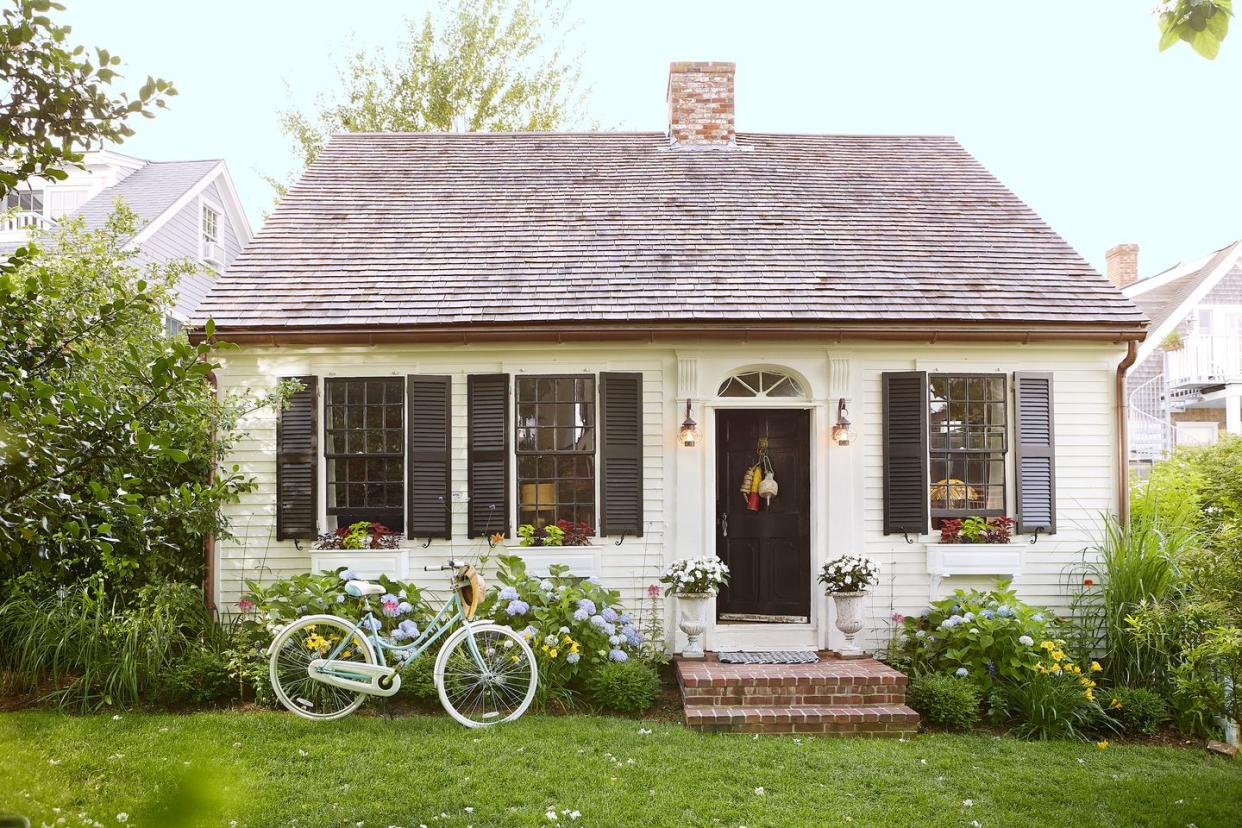 home of steve ballerini and colin bohrer, one of the oldest cape cottages in provincetown, massachusetts cape cod cottage, cape cod style home exterior, black front door