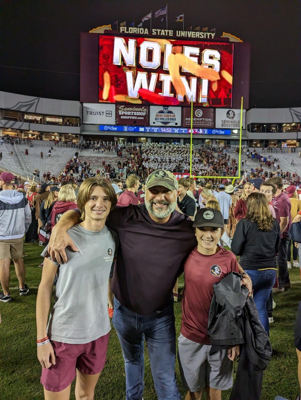 FSU and Leon High graduate Brian Sauls with sons Lincoln, left, and Brogan were among the thousands of fans who rushed the field following the Seminoles' home win over Florida last month.