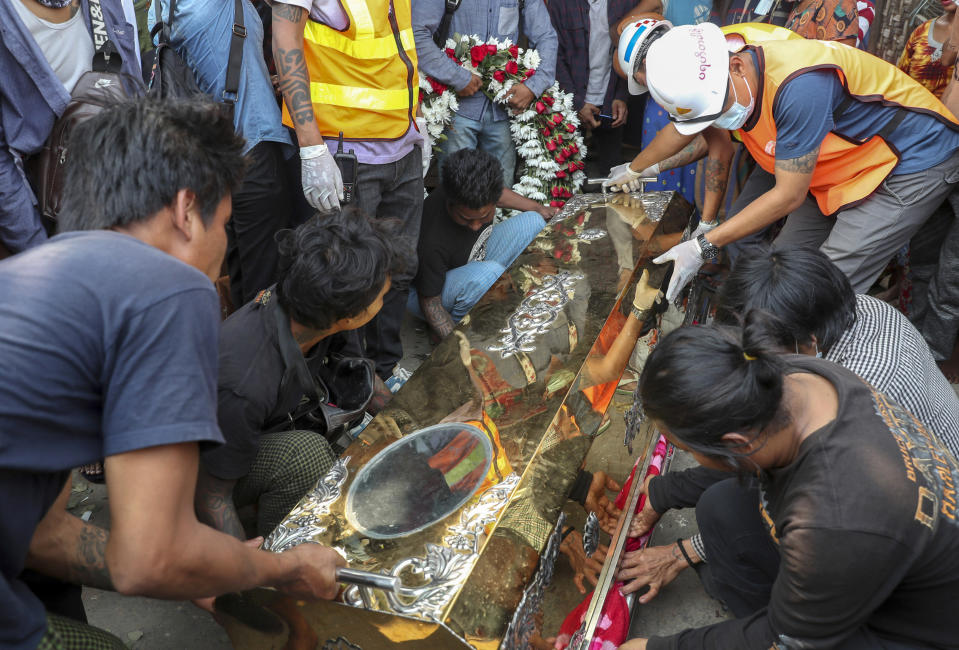 The body of Saw Pyae Naing is placed in a coffin in Mandalay, Myanmar, Sunday, March 14, 2021. Saw Pyae Naing, a 21-year old anti-coup protester, was shot and killed by Myanmar security forces during a demonstration on Saturday, according to his family. (AP Photo)