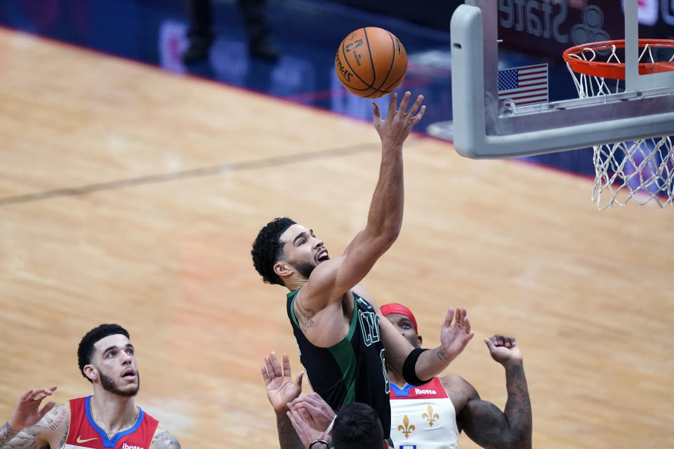 Boston Celtics forward Jayson Tatum (0) goes to the basket in the second half of an NBA basketball game against the New Orleans Pelicans in New Orleans, Sunday, Feb. 21, 2021. (AP Photo/Gerald Herbert)