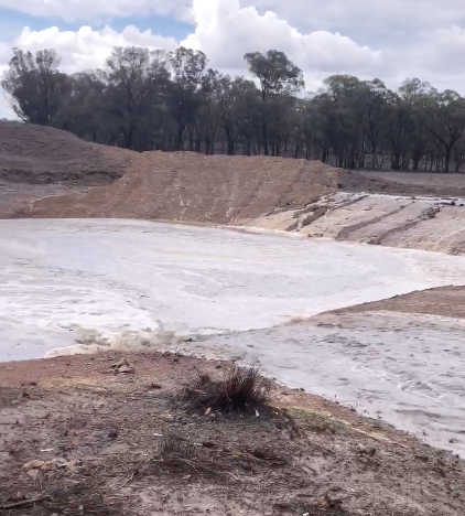 Rainfall is seen streaming into the family’s Bundarra dam on Thursday. Source: Lindsay Groth