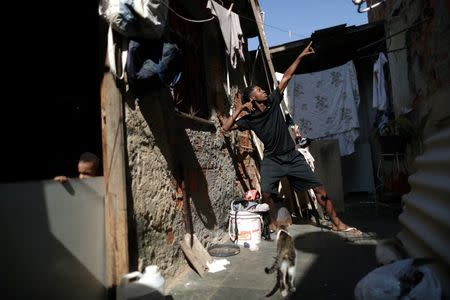 Tiago Cantanhede, 15, who trains in the Mangueira Olympic Village, poses outside his grandmother's house in Escondidinho slum in Rio de Janeiro, Brazil, August 16, 2016. REUTERS/Ricardo Moraes