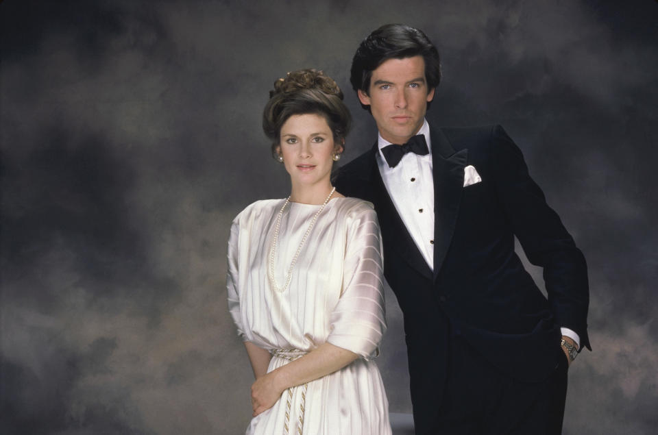 REMINGTON STEELE -- Pictured: (l-r) Stephanie Zimbalist as Laura Holt, Pierce Brosnan as Remington Steele  (Photo by NBCU Photo Bank/NBCUniversal via Getty Images via Getty Images)