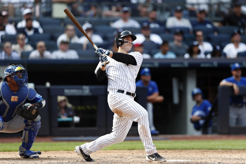 New York Yankees' Anthony Rizzo, right, follows through on a home run against the Kansas City Royals during the seventh inning of a baseball game Sunday, July 31, 2022, in New York. (AP Photo/Noah K. Murray)