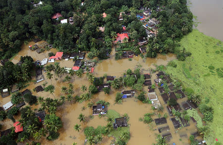 An aerial view shows partially submerged houses at a flooded area in Kerala, August 17, 2018. REUTERS/Sivaram V