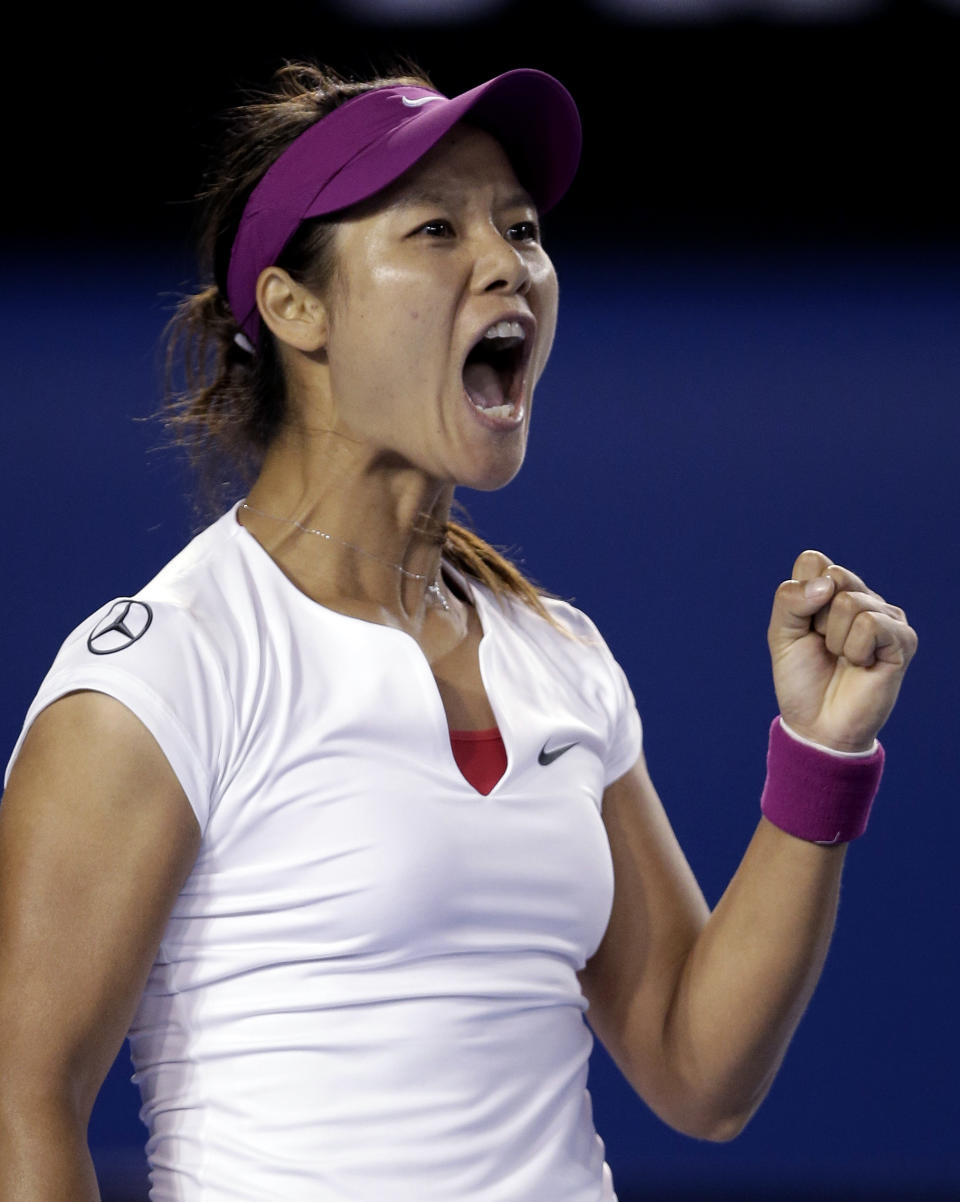 Li Na of China celebrates winning the first set over Dominika Cibulkova of Slovakia during their women's singles final at the Australian Open tennis championship in Melbourne, Australia, Saturday, Jan. 25, 2014.(AP Photo/Rick Rycroft)