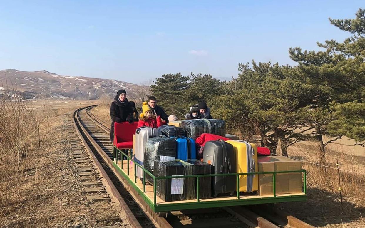 Staff members of the Russian embassy in North Korea and their family members use a hand-pushed rail trolley as they travel from the Russian border station of Khasan in the Russian Far East during their journey from North Korea. The diplomats and their family members made a 32-hour train journey and a two hour bus ride in North Korea, and then crossed the border to Russia using the rail trolley. North Korea has blocked most passenger transport due to COVID-19 restrictions. - Russian Ministry of Foreign Affairs/TASS