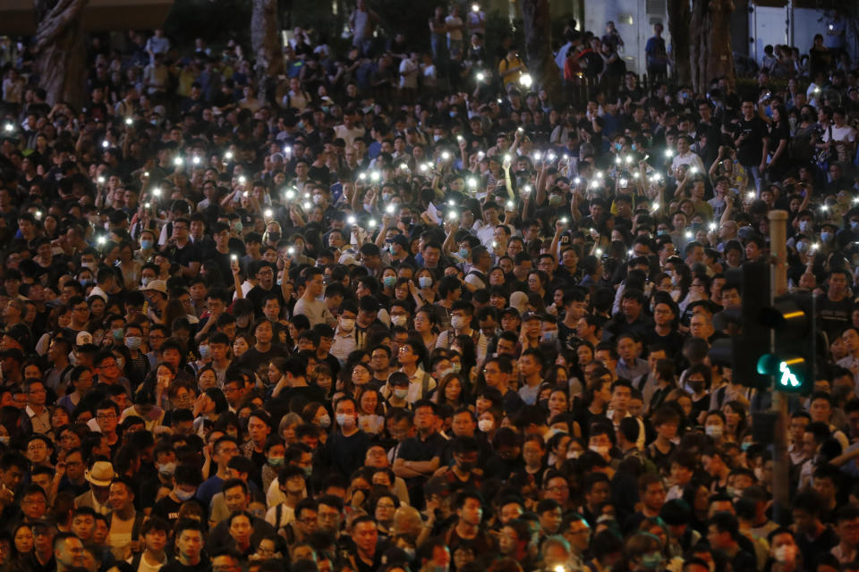 Protesters hold up the lights on their phones as they gather at a demonstration by civil servants in Hong Kong on Friday, Aug. 2, 2019. Protesters plan to return to the streets again this weekend, angered by the government's refusal to answer their demands, violent tactics used by police, possibly in coordination with organized crime figures. (AP Photo/Vincent Thian)