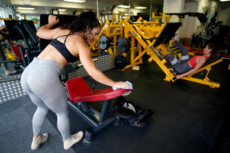 Gym members are seen sanitising gym equipment after working out at Ultimate Fitness Gym