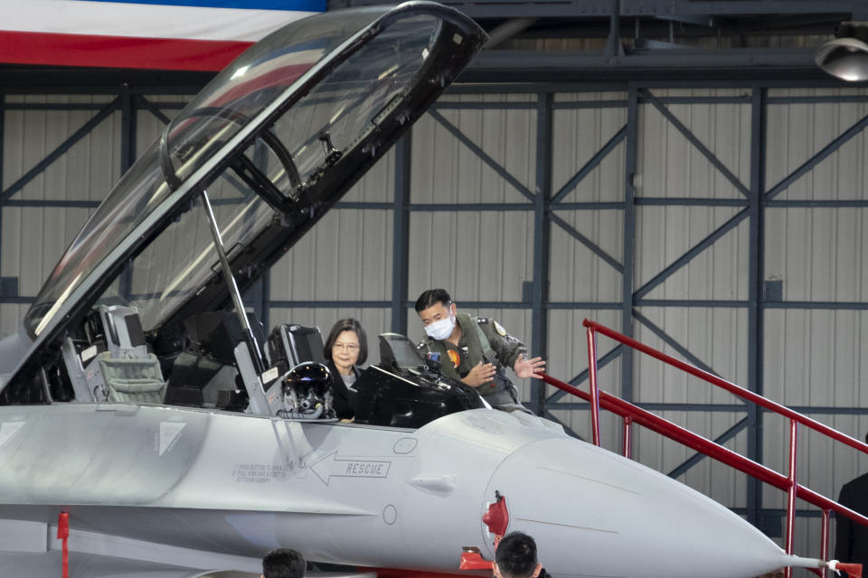 Taiwan's President Tsai Ing-wen sitting in the cockpit is briefed during a ceremony to commission into service 64 upgraded F-16V fighter jets at an Air Force base in Chiayi in southwestern Taiwan Thursday, Nov. 18, 2021. Taiwan has deployed the most advanced version of the F-16 fighter jet in its Air Force, as the island steps up its defense capabilities in the face of continuing threats from China. (AP Photo/Johnson Lai)