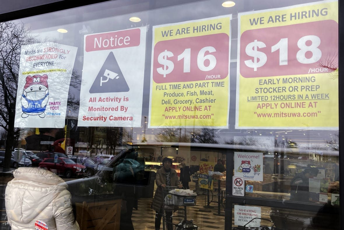 Hiring signs are displayed at a grocery store in Arlington Heights, Ill., Jan. 13, 2023. (AP Photo/Nam Y. Huh, File)