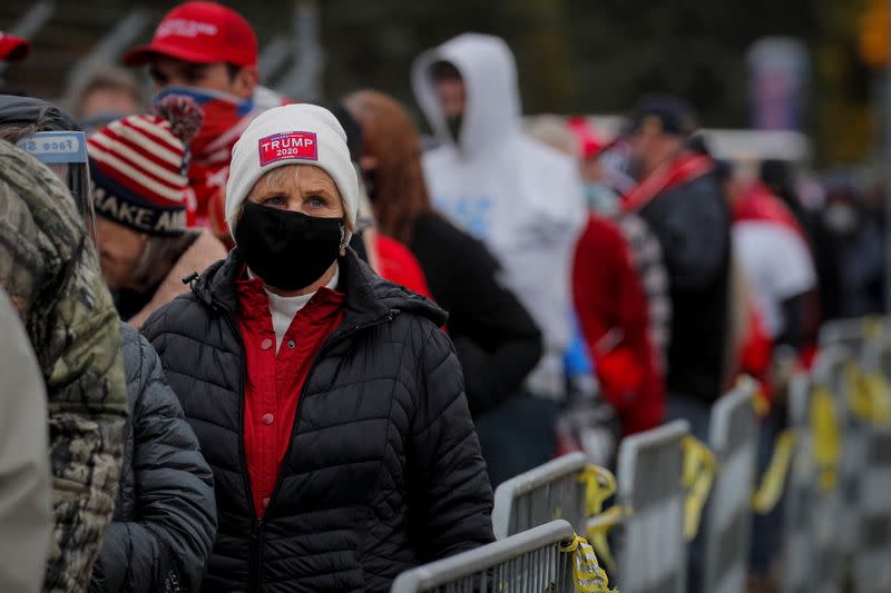 Supporters of U.S. President Trump wait in line to attend his campaign event in Erie