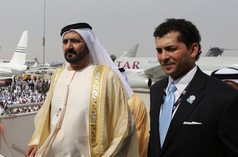 UAE Vice President, Prime Minister and Ruler of Dubai, Sheikh Mohammed bin Rashid Al Maktoum, left, walks into an Emirates Airbus A380 plane with Sharief Fahmy, CEO of F&E Aerospace during the opening day of the 12th Dubai Airshow in Dubai, United Arab Emirates, Sunday, Nov. 17, 2013. The Dubai Airshow is seen as an increasingly important barometer on the state of the industry and the rising roles of the big-spending Gulf carriers Etihad, Qatar Airways and Emirates as they compete for routes and critical stopover traffic between Asia and Europe and the Americas. (AP Photo/Kamran Jebreili)