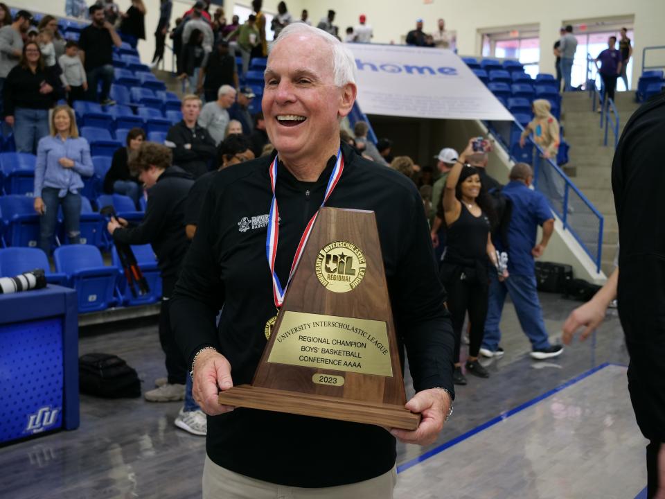 Randall coach Leslie Broadhurst revels in his team winning the Region I-4A boys' basketball tournament last year at the Rip Griffin Center in Lubbock. The Raiders repeated as regional champions last weekend, earning the program's first two trips to state under the coach who's led them for 36 years.