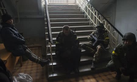 Members of the Ukrainian armed forces gather inside a school building in Debaltseve, Donetsk region, January 30, 2015. REUTERS/Maksim Levin