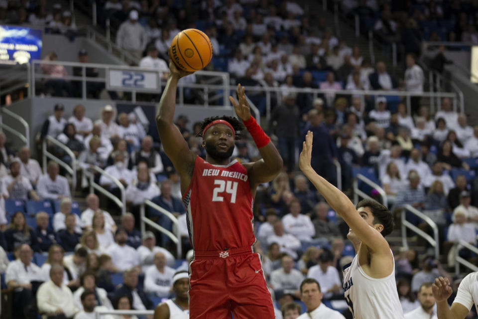 New Mexico forward Morris Udeze (24) shoots against Nevada during the first half of an NCAA college basketball game in Reno, Nev., Monday, Jan. 23, 2023. (AP Photo/Tom R. Smedes)