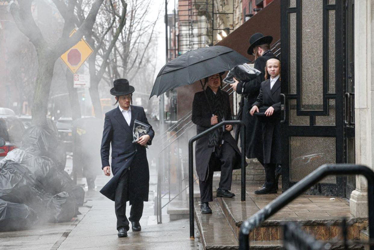 Men arrive to a Orthodox Synagogue in Brooklyn on December 30, 2019 in New York City, two days after an intruder wounded five people at a rabbis house in Monsey, New York during a gathering to celebrate the Jewish festival of Hanukkah.