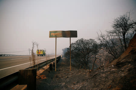 A fire truck is seen on Pacific Coast Highway as the Woolsey Fire continues to burn in Malibu, California, U.S., November 10, 2018. REUTERS/Eric Thayer