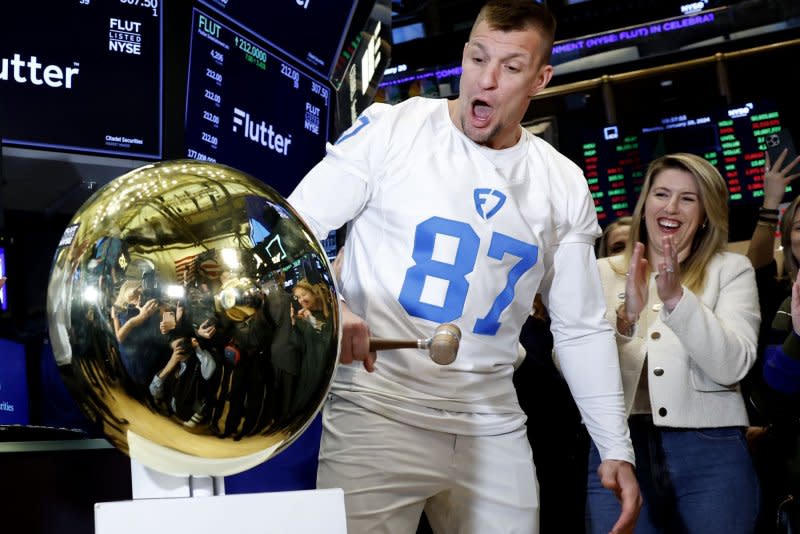 Former NFL tight end Rob Gronkowski rings the bell on the floor of the New York Stock Exchange on Monday, officially launching trading of Flutter under the ticker symbol FLUT. Photo by John Angelillo/UPI