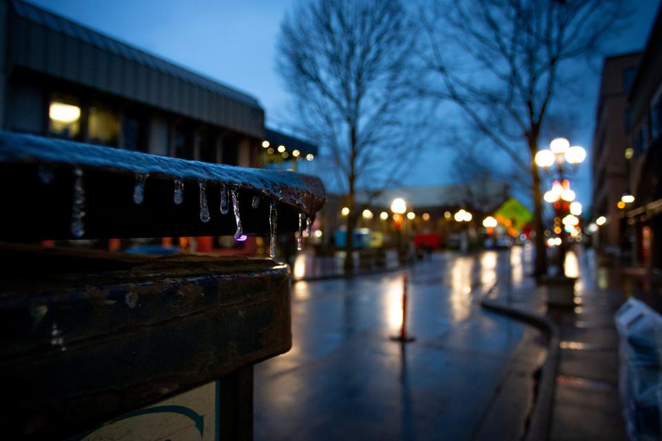 Icicles hang from a dumpster in downtown Eugene as the sun sets Thursday.