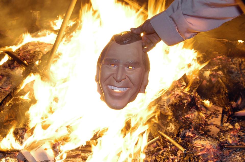 Anti-Bush protesters gather around a bonfire in London's Trafalgar Square, with thousands of protesters taking part in an anti-war demonstration on the second day of President George W. Bush's 2003 state visit. (Photo: Edmond Terakopian - PA Images via Getty Images)